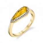 A gold gemstone ring with diamonds